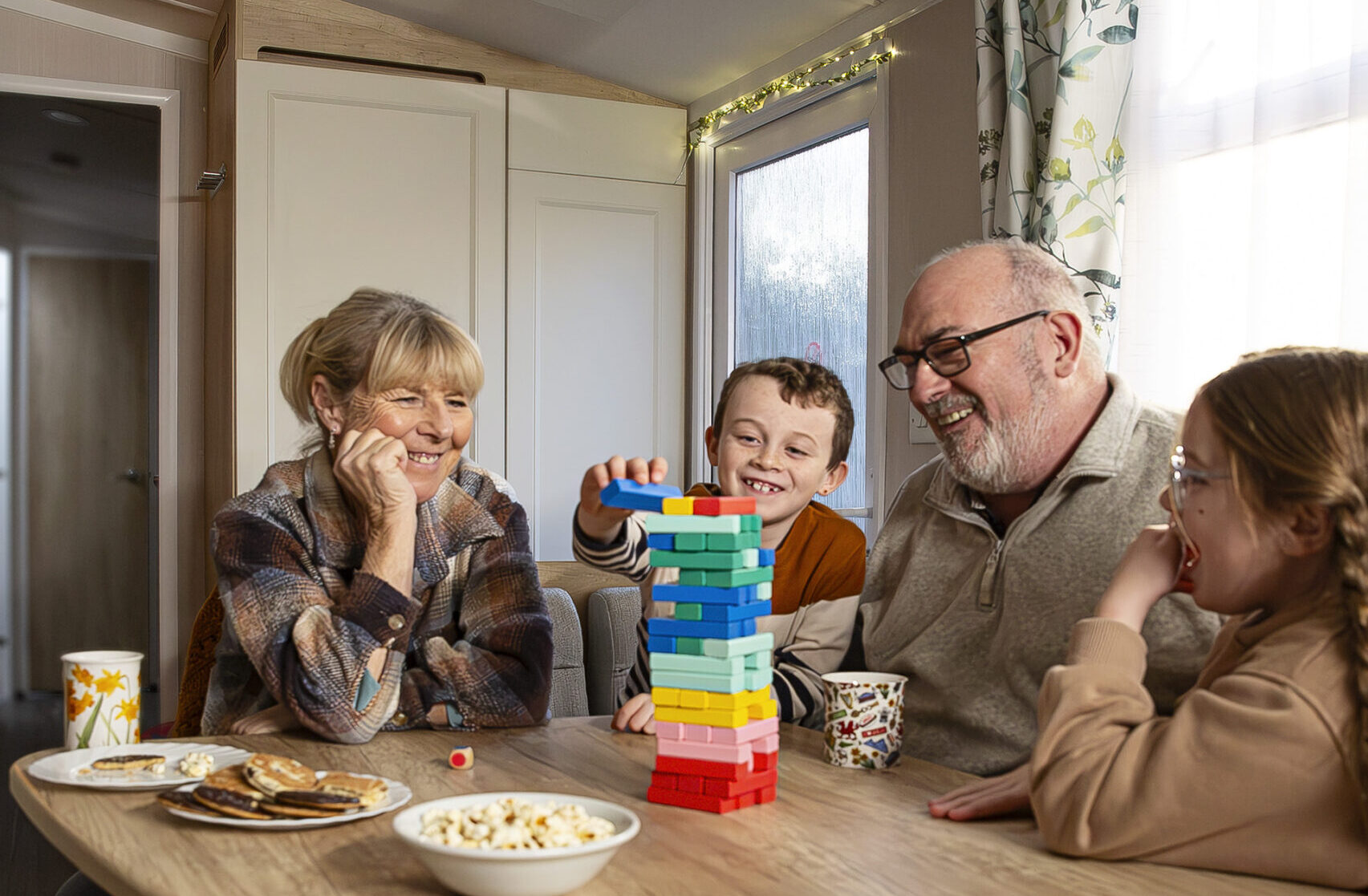 Foster carers and two young children playing with blocks