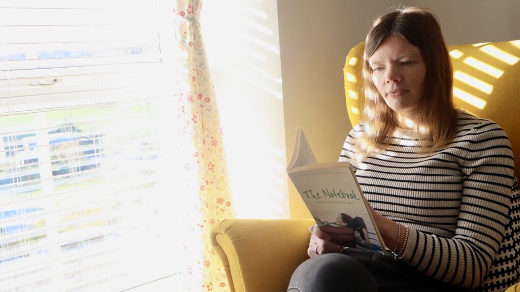 Foster carer Meleri reading a book